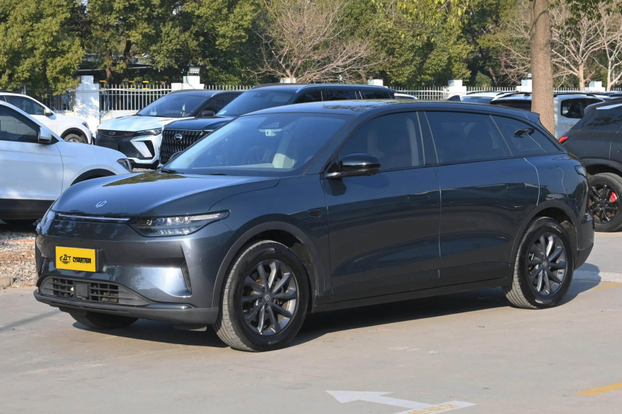 Matte dark gray EV wagon with sleek LED headlights and multi-spoke alloy wheels