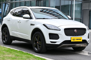 White Jaguar E-Pace premium compact luxury SUV three-quarter front shot parked outside modern glass building