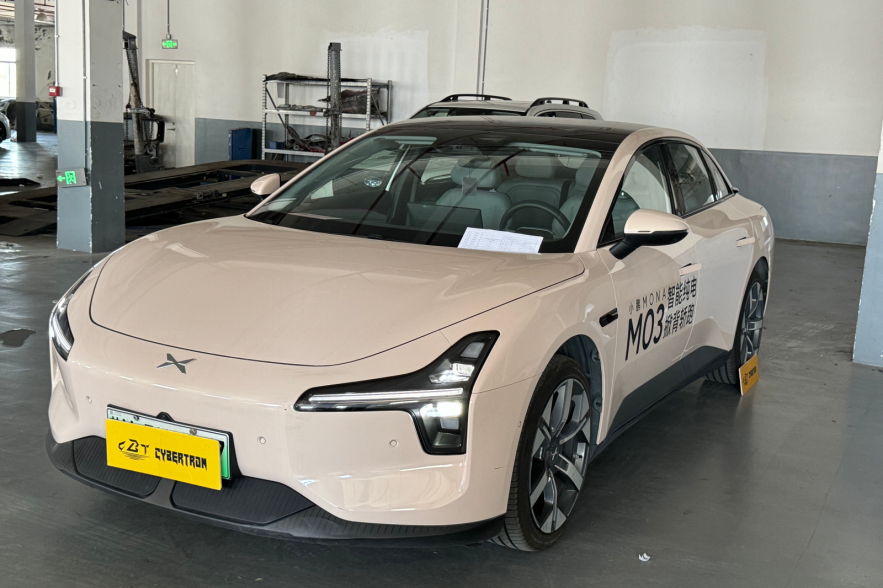 Light pink electric car parked indoors.