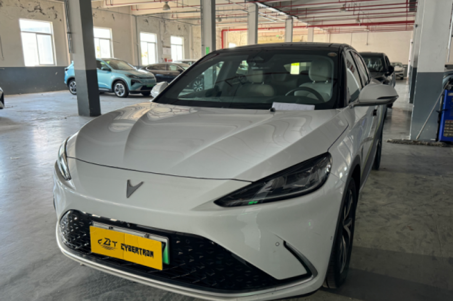 White Neta electric sedan: sleek fastback design, modern EV styling, ideal for eco-friendly urban commuting & smart mobility.