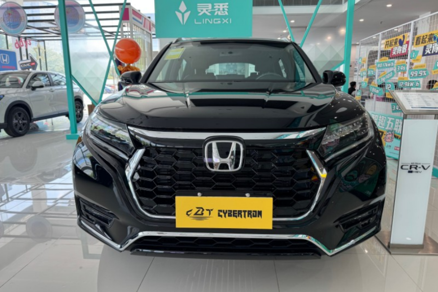 Black Honda SUV front view in car showroom, iconic logo, yellow license plate, modern dealership interior decor.