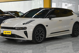 White Zeekr 001 electric shooting brake three-quarter front view displayed inside indoor car dealership showroom