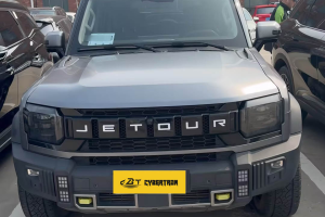 Gray Jetour rugged off-road SUV front close-up, bold Jetour letter grille displayed in outdoor vehicle lot