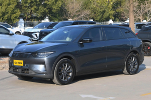 Matte dark gray EV wagon with sleek LED headlights and multi-spoke alloy wheels