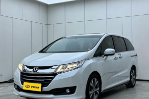 White Honda Odyssey family MPV three-quarter front view shot inside clean minimalist indoor car photography studio