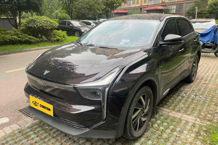 Black SUV parked in a residential area, front view.