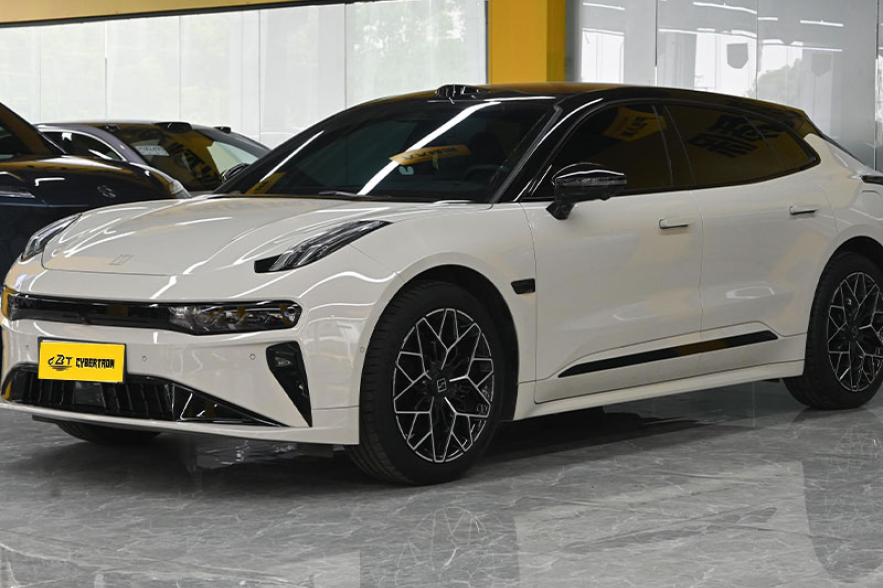 White Zeekr 001 electric shooting brake three-quarter front view displayed inside indoor car dealership showroom